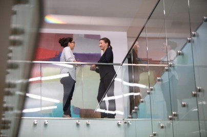 two women talking in an office building