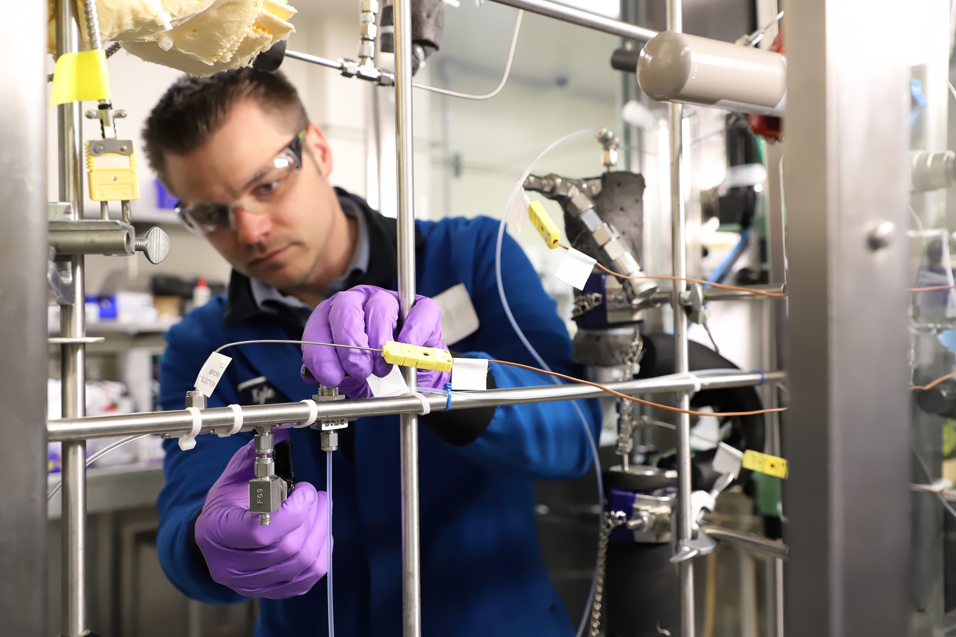 Person working in lab using valve