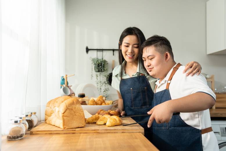 Mother and son baking wearing apron