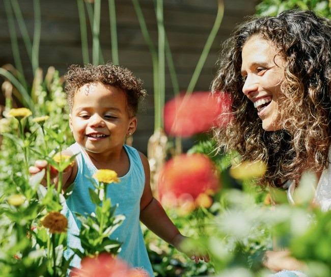 parent and child picking flowers