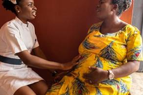 Healthcare professional comforting pregnant women