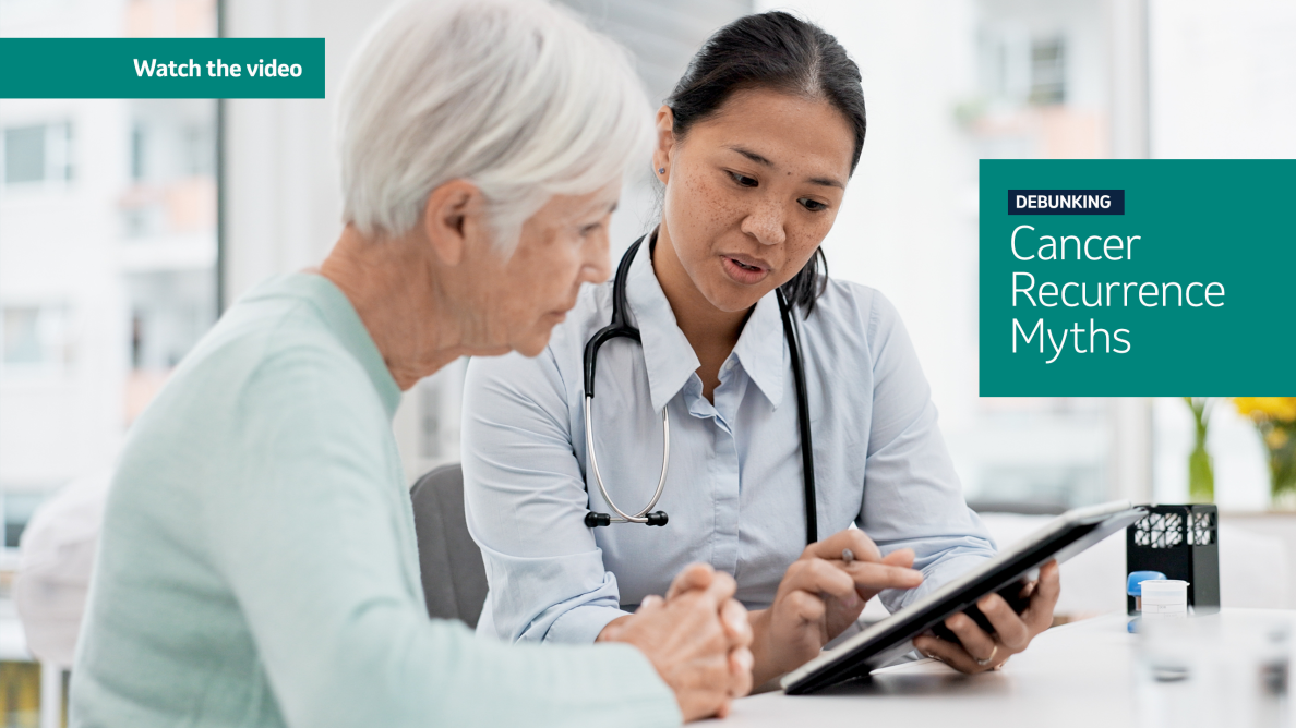 doctor holding a clipboard and pointing to it to the woman sitting next to her.