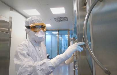 person in full protective gear working in facility