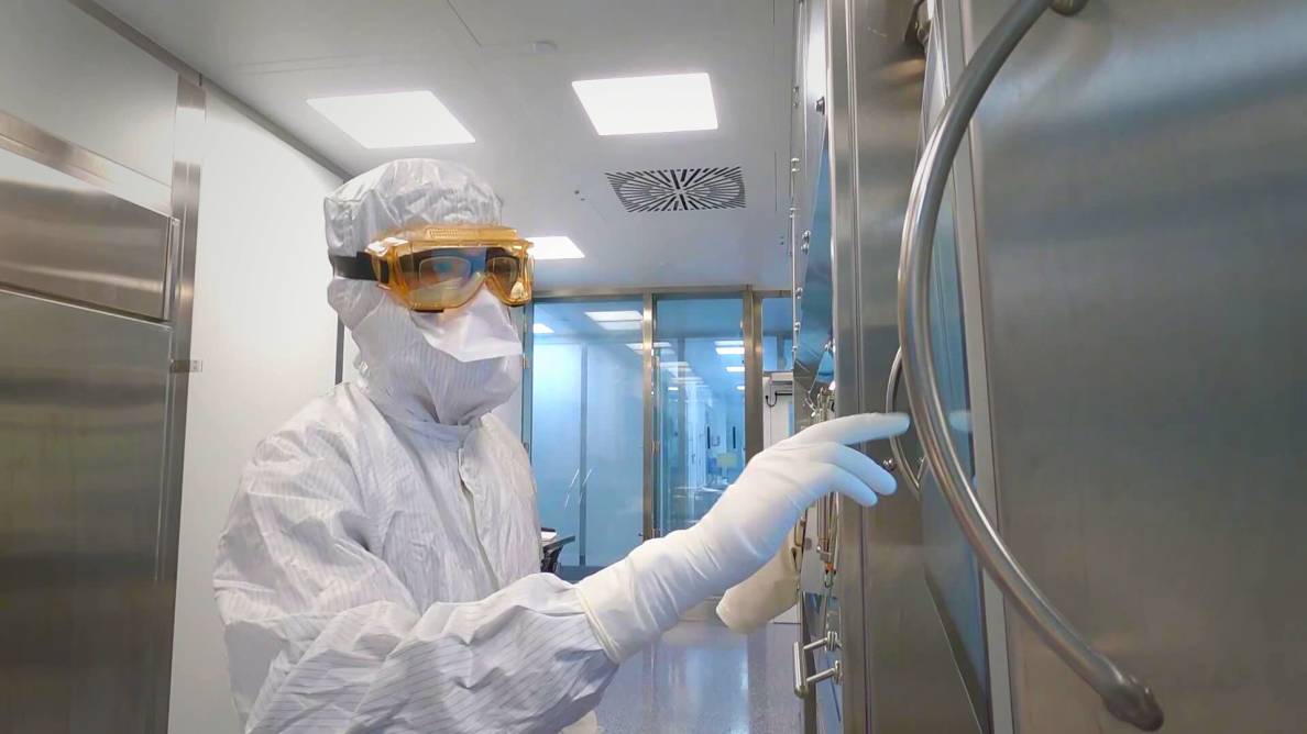 person in full protective gear working in facility