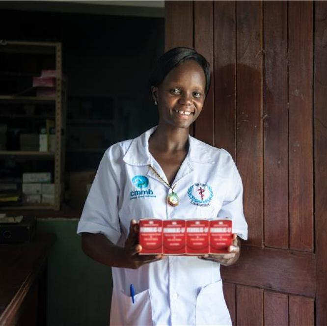 Women in white coat standing next to wooden door