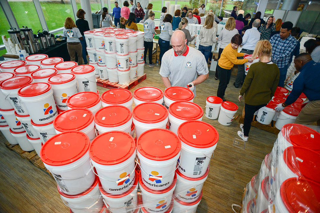 Group of people organizing red buckets