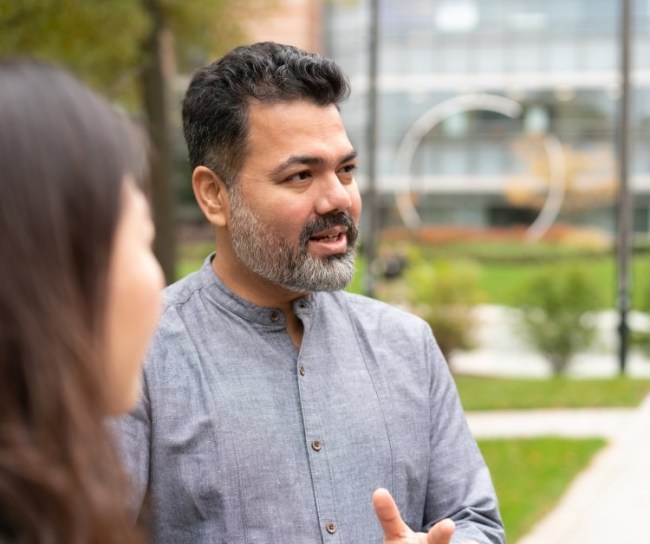 Two employees outside talking