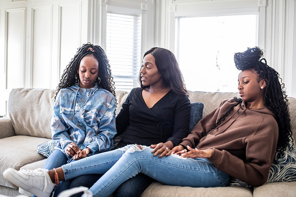 Three women sitting on couch