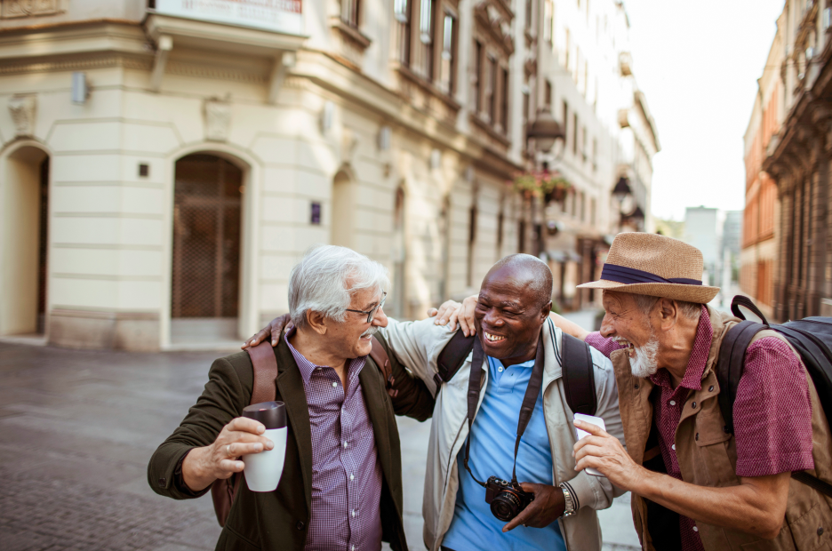 Three people outdoors smiling.