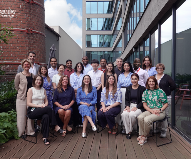 group of at least 20 people smiling for the photo