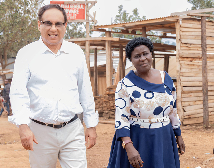 Cyrus Badshah, M.D., Ph.D, MSD senior principal scientist and Joyce Matovu, site hospital liaison coordinator at MU-JHU Care Ltd., tour the Namulanda Mukikadde gold mine community in the Mityana district.