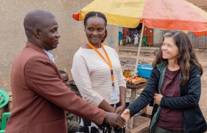 Rebeca Plank, M.D., Ph.D. (right) and Joan Nabawanuka, community liaison officer at MU-JHU Care Ltd., meet with Kibuuka Yahaya Galabuzi, local leader of Katiko Fishing Village in the Mityana district