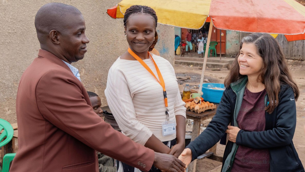 Rebeca Plank, M.D., Ph.D. (right) and Joan Nabawanuka, community liaison officer at MU-JHU Care Ltd., meet with Kibuuka Yahaya Galabuzi, local leader of Katiko Fishing Village in the Mityana district