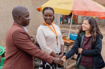 Rebeca Plank, M.D., Ph.D. (right) and Joan Nabawanuka, community liaison officer at MU-JHU Care Ltd., meet with Kibuuka Yahaya Galabuzi, local leader of Katiko Fishing Village in the Mityana district