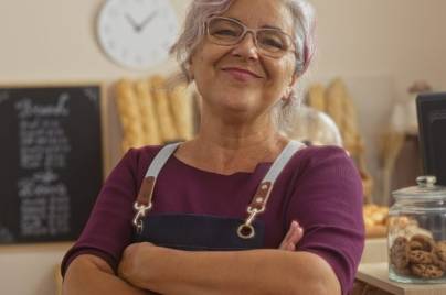 Woman standing in bakery smiling