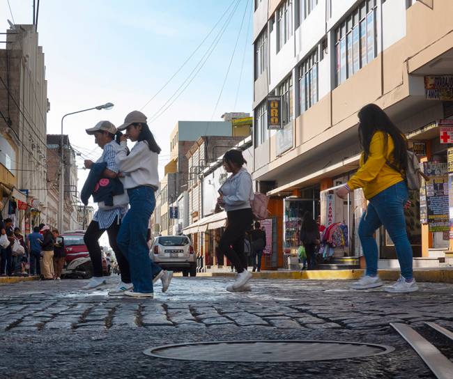Four women crossing a city street